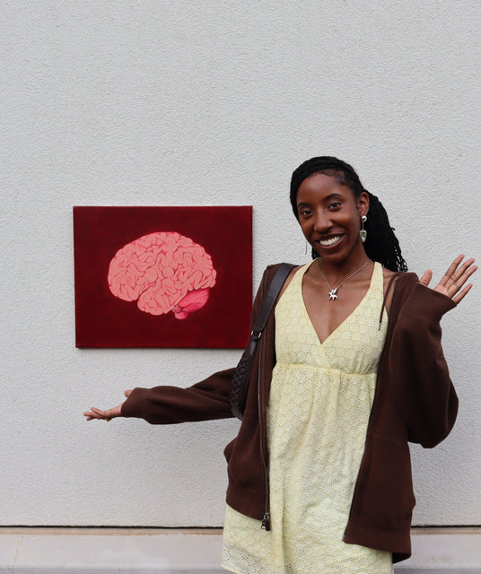 Artist Aviana Jackson pictured with her painting "ITSNOTABRAIN"